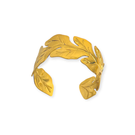 Gold-tone open cuff bracelet with sculpted overlapping leaf design.